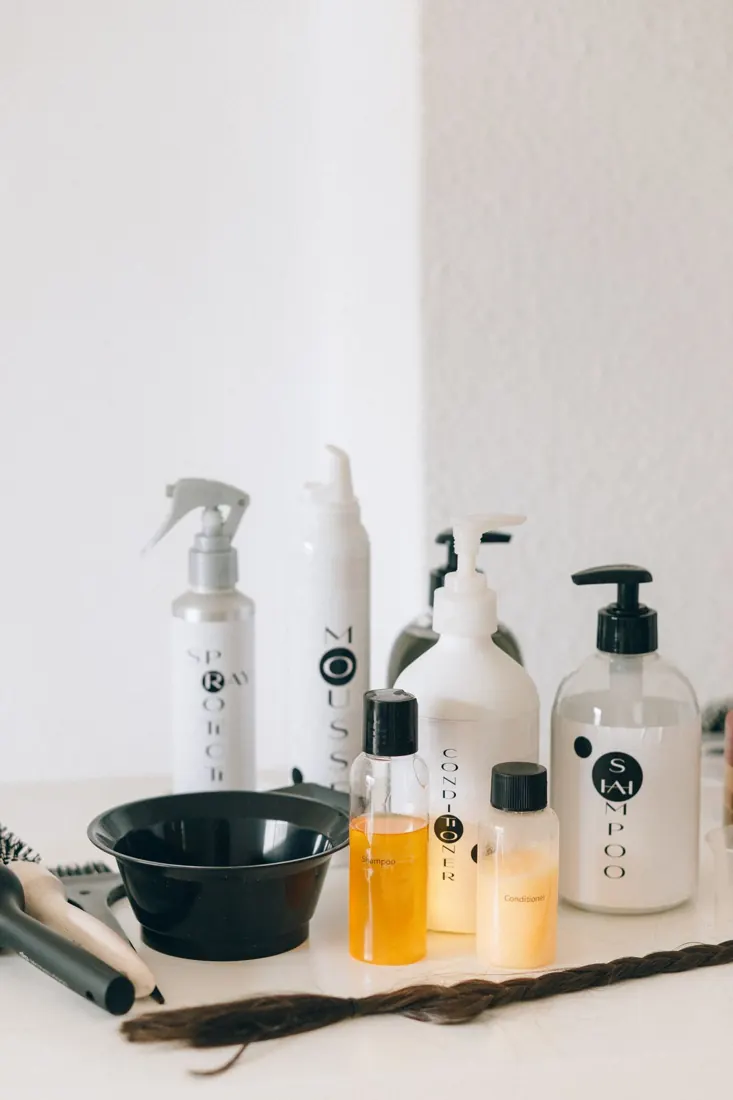 Hair styling tools and containers on a counter
