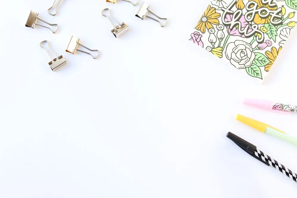 Pens, clips and stationery on a white surface