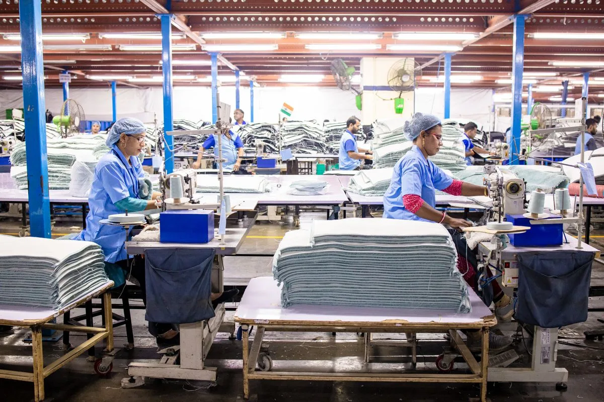 Workers and sewing machines in a textile production facility